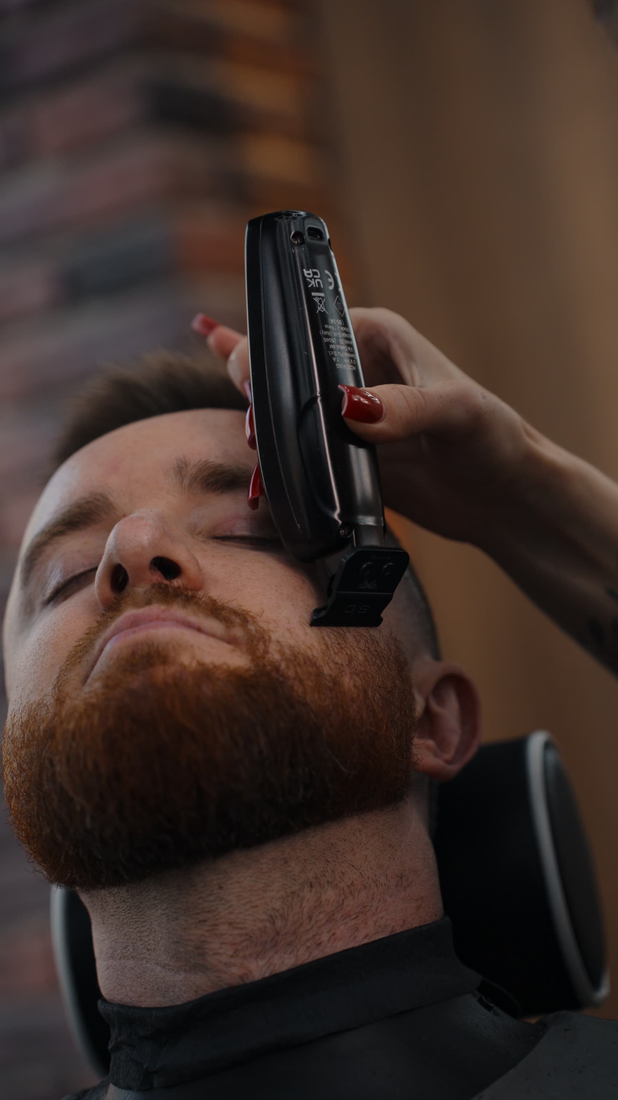 Man getting his bear trimmed